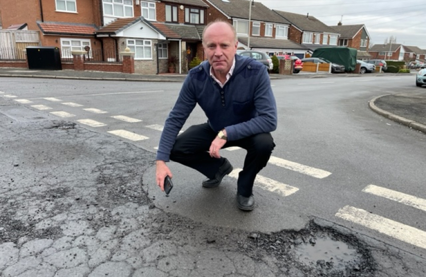 Marco Longhi MP examining the road condition on the Foxyards Estate in Dudley